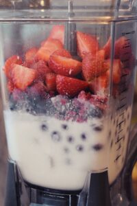 making a mixed berry smoothie 