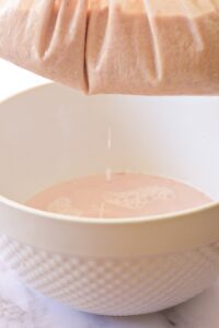 straining almond milk